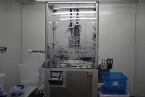 Mini mono being installed within a clean room, for pharmaceutical filling and capping.