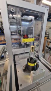 CC1440 Benchtop Capping Machine showing odd shaped perfume bottle within a custom 3D printed carbon fiber jig.