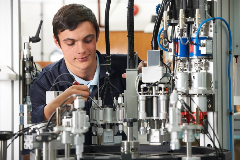 Operator adjusting torque settings on a bottling and capping machine.