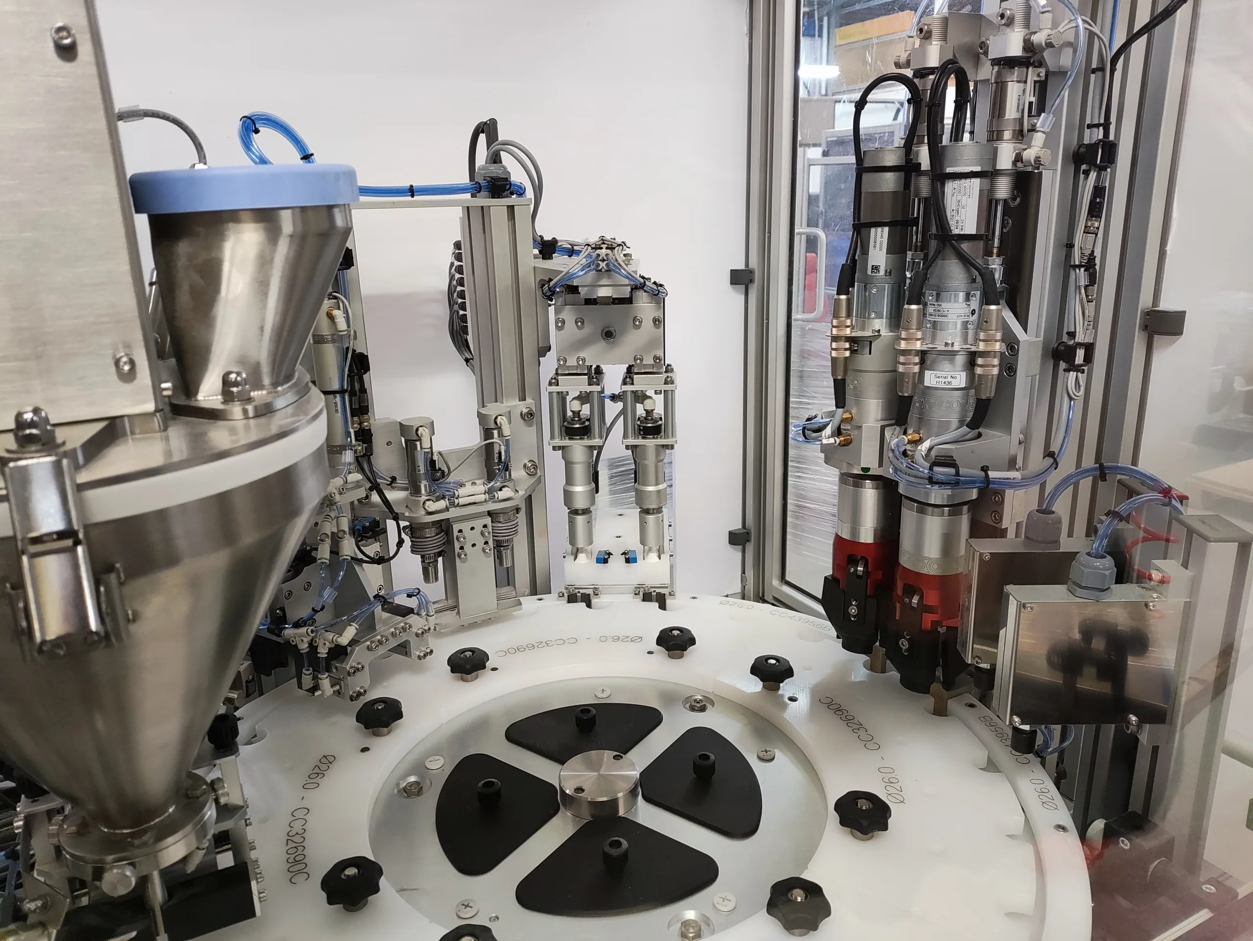 Powder filling machine dispensing precise portions into containers.