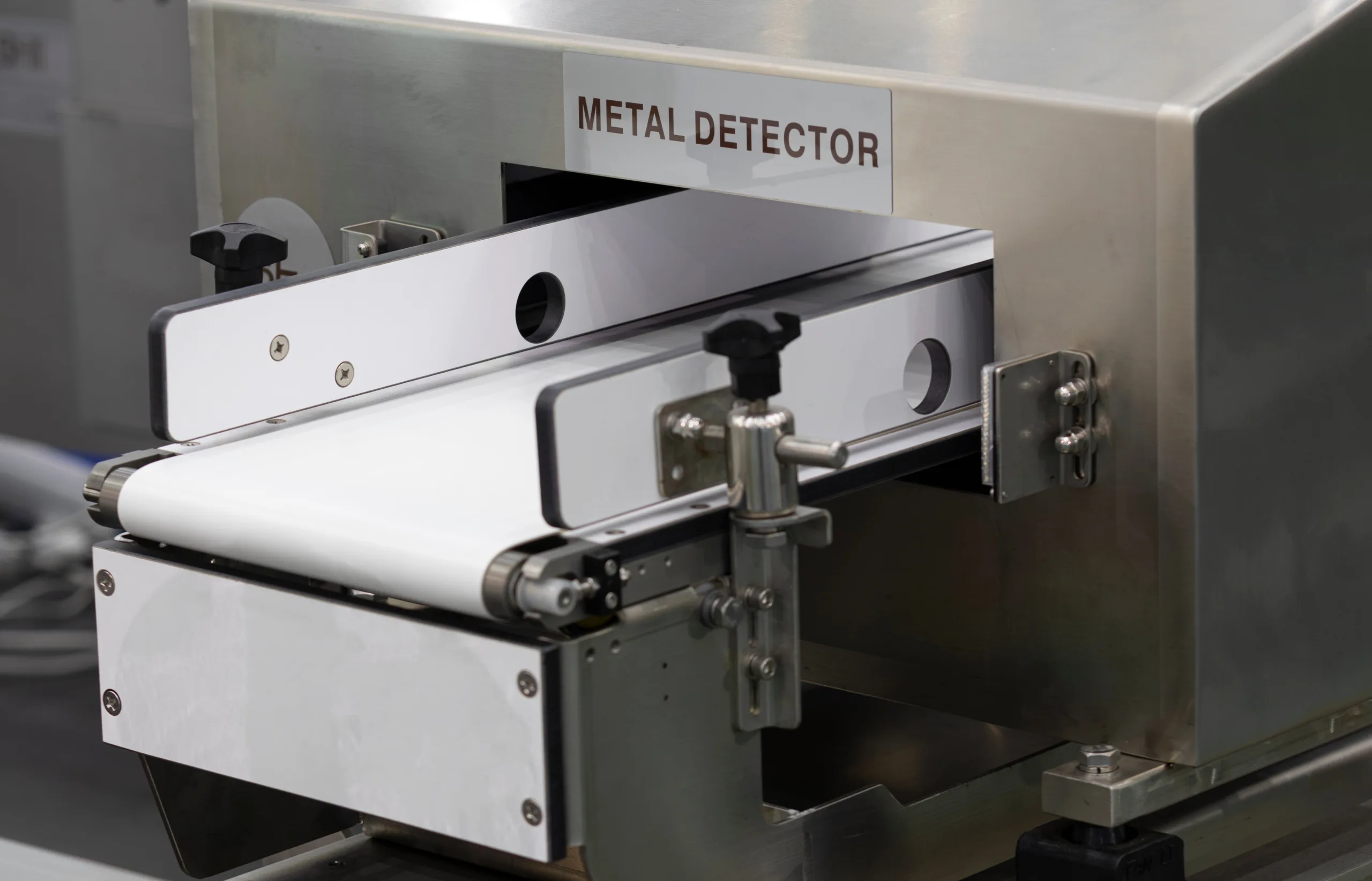 Inline metal detection machine identifying and removing ferrous contamination.