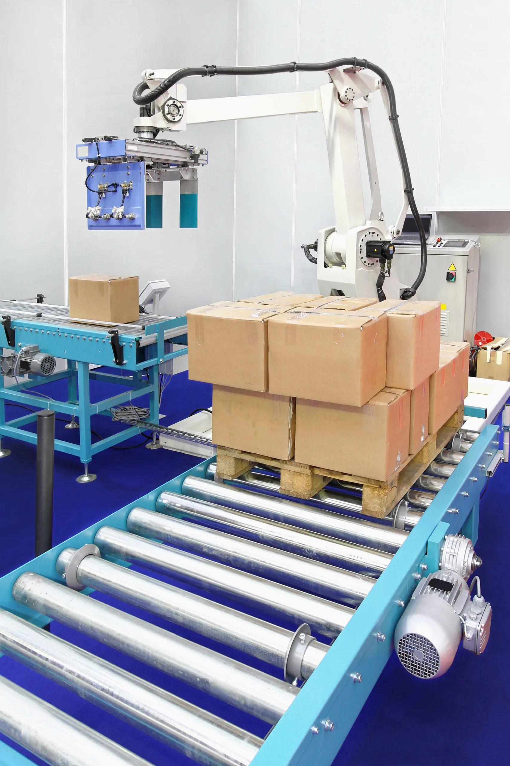 Palletising machine stacking finished products efficiently for storage or shipment.