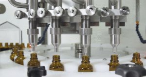 Close up of the four head filling nozzles of a CC560 Filling machine with gear pumps.