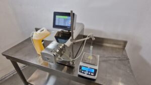 Delta Fill on a stainless steel bench, setup to take scaled readings during running.