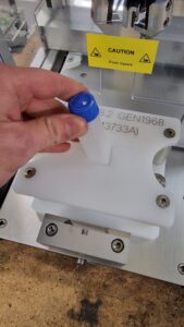 CC1440 Benchtop Capper, showing square vial being placed into capping jig.